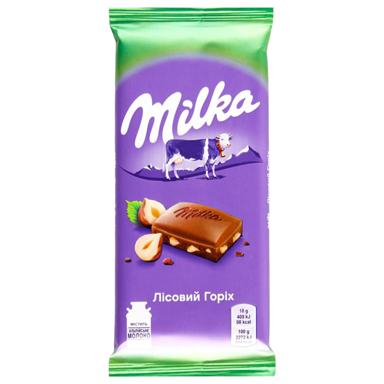 Шоколад молочний Milka з подрібненими лісовим горіхом 90г — фото продукту